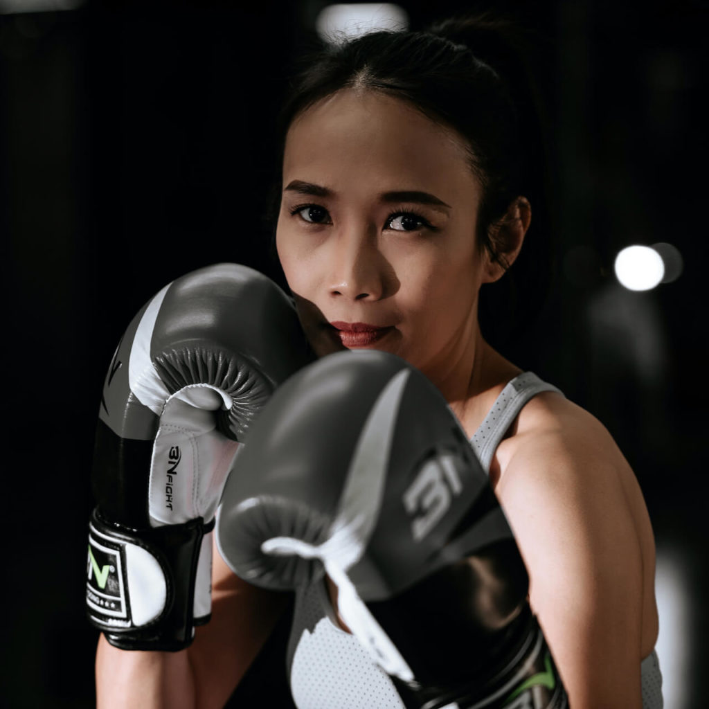 Woman with boxing gloves set up to fight. The high stress state of Fight is God's design for us to fight an opponent when we're in danger, and survive.