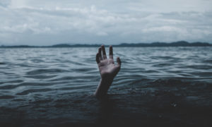 Hand reaching out from under the water of a lake for help. When we're stressed to our limits we are crippled with fear, feeling like we're drowning, just reaching for God to save us. Elijah felt this crippling fear too.