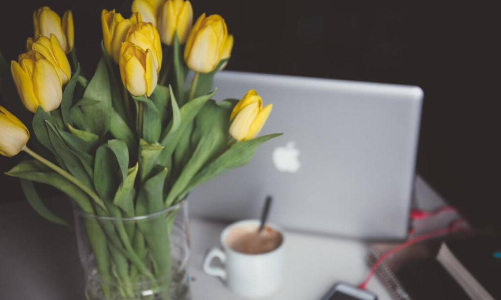 Laptop with coffee and tulips